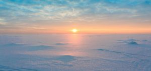 Arctic, low sun over frozen landscape