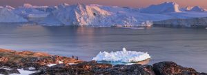 Tourists viewing huge icebergs in Ilulissat Icefjord