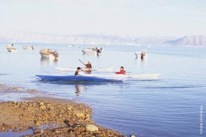 Inuit children in kayaks